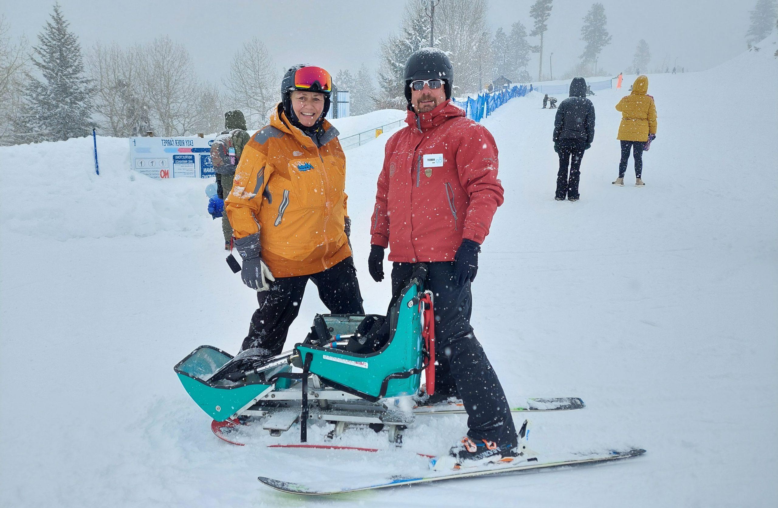 Employee Robert Walters and woman with an adaptive snow ski